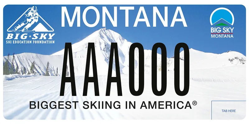 A license plate with a photo of groomed ski trails and a mountain peak. Blue sky. Top left is Big Sky Ski Education Foundation logo and top right is Big Sky Montana logo. Bottom say Biggest Skiing in America.