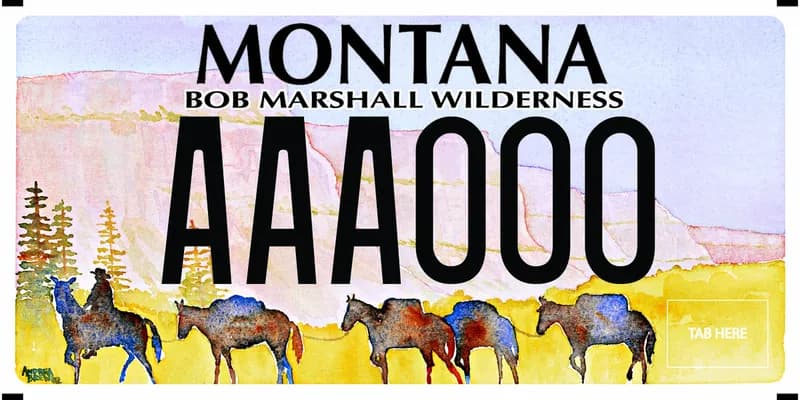 A license plate with black text. A watercolor of the bob marshall wilderness and the chinese wall. Colored silhouettes of a cowboy on horseback leading four horses. Top text says Bob Marshall Wilderness.