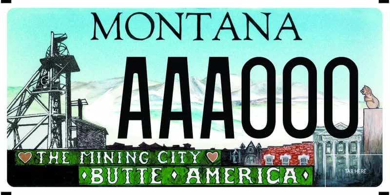 A license plate with white and black text. And illustration of butte architecture and a headframe. Bottom text says The Mining City and Butte, America.