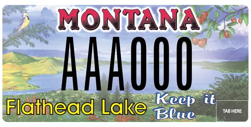 A license plate with red, black, yellow, and white text. An illustration of Flathead lake, Mission Mountains, a Meadowlark, and cherries on a tree. Bottom of plate says Flathead Lake and Keep in Blue.