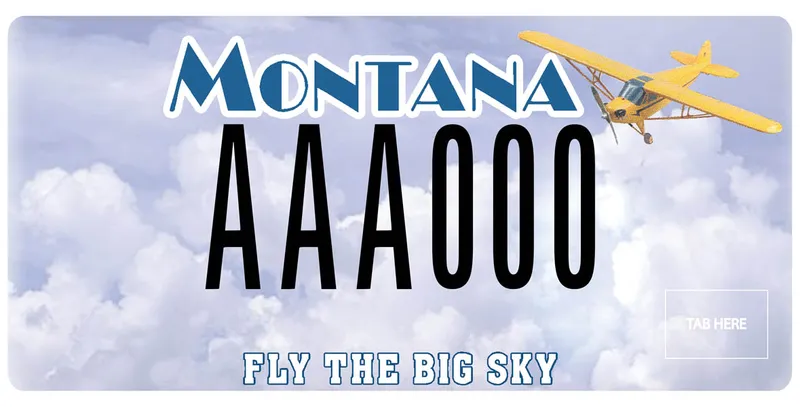 A license plate with black and blue text and clouds as background. A small plane in upper right corner. Bottom text says Fly the Big Sky.
