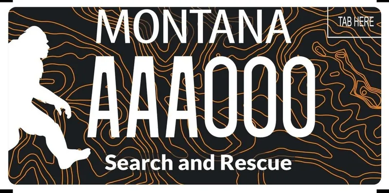 A license plate with white text and a black background covered with orange topography design lines. White silhouette of big foot is on the left. Bottom says Search and Rescue.
