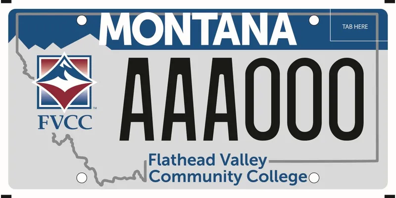 A gray license plate with a darker gray outline of the state. Top has blue bar. Bottom says Flathead Valley Community College and their official logo is on left side and says FVCC.