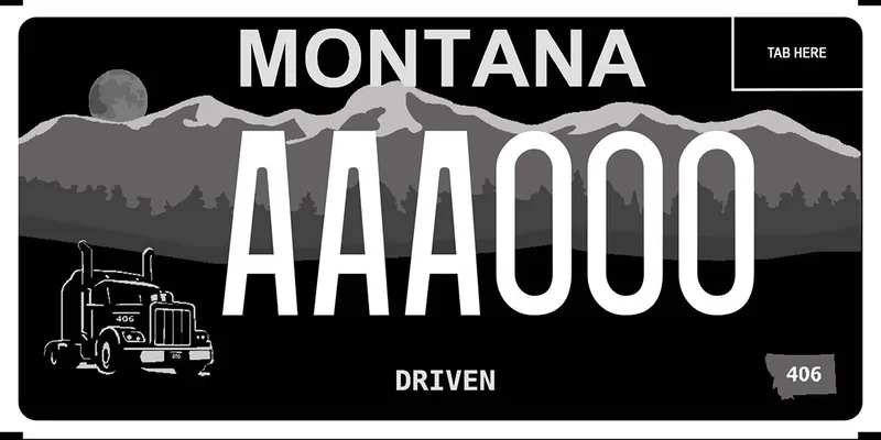 A black and grayscale license plate with white text. Mountain graphics in background. A semi truck cab on the left side. Bottom says driven.