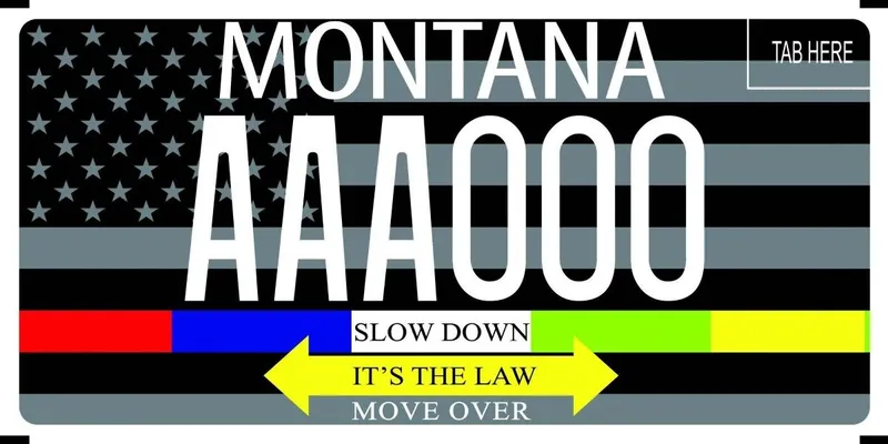 A license plate with white and black text. A black and gray American flag as background. Bottom has a red, blue, lime green, and florecent yellow bar across the plate with the words Slow Down in middle. Below is a yellow arrow pointing both directions that says It's the Law, below says Move Over.