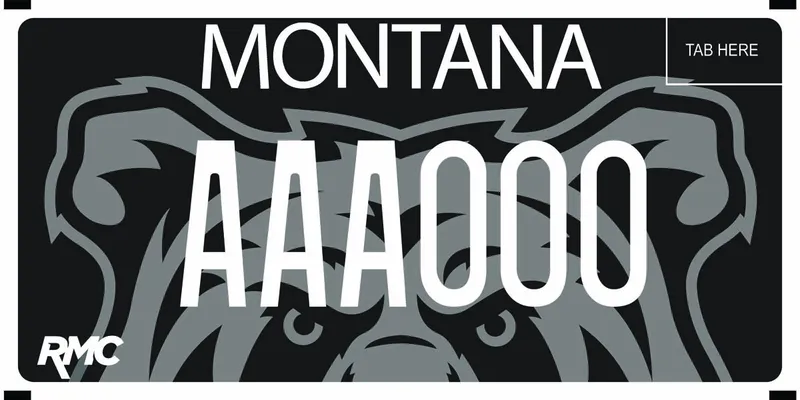 A black and gray license plate with white text. Half of an illustrated bear face across whole plate. Bottom says RMC.