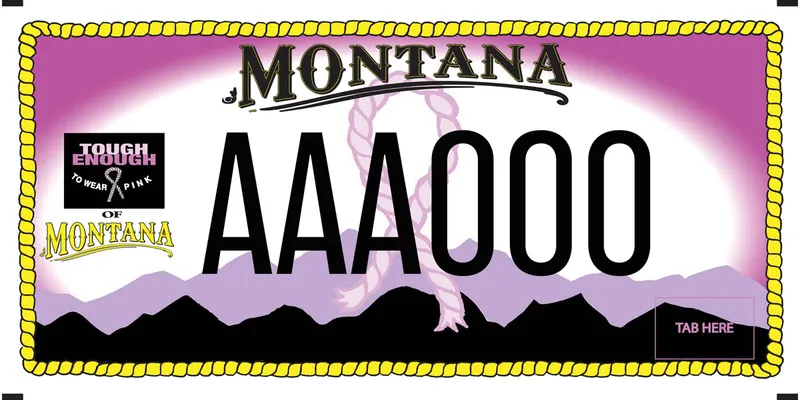 A pink license plate with a yellow rope border and black text. A pink ribbon in the middle. Black and purple silhouette mountains along bottom. Tough Enough to Wear Pink of Montana logo on left.