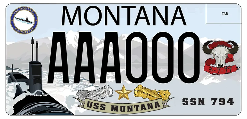 A license plate with black text and an illustrated mountain scene with a submarine emerging from water. Bottom says USS Montana, SSN 794. Top left corner is USS Montana Committee logo. Buffalo skull with a red banner that says 3 7 77 on right.